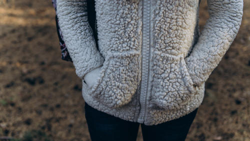 womans hands in fluffy hoodie